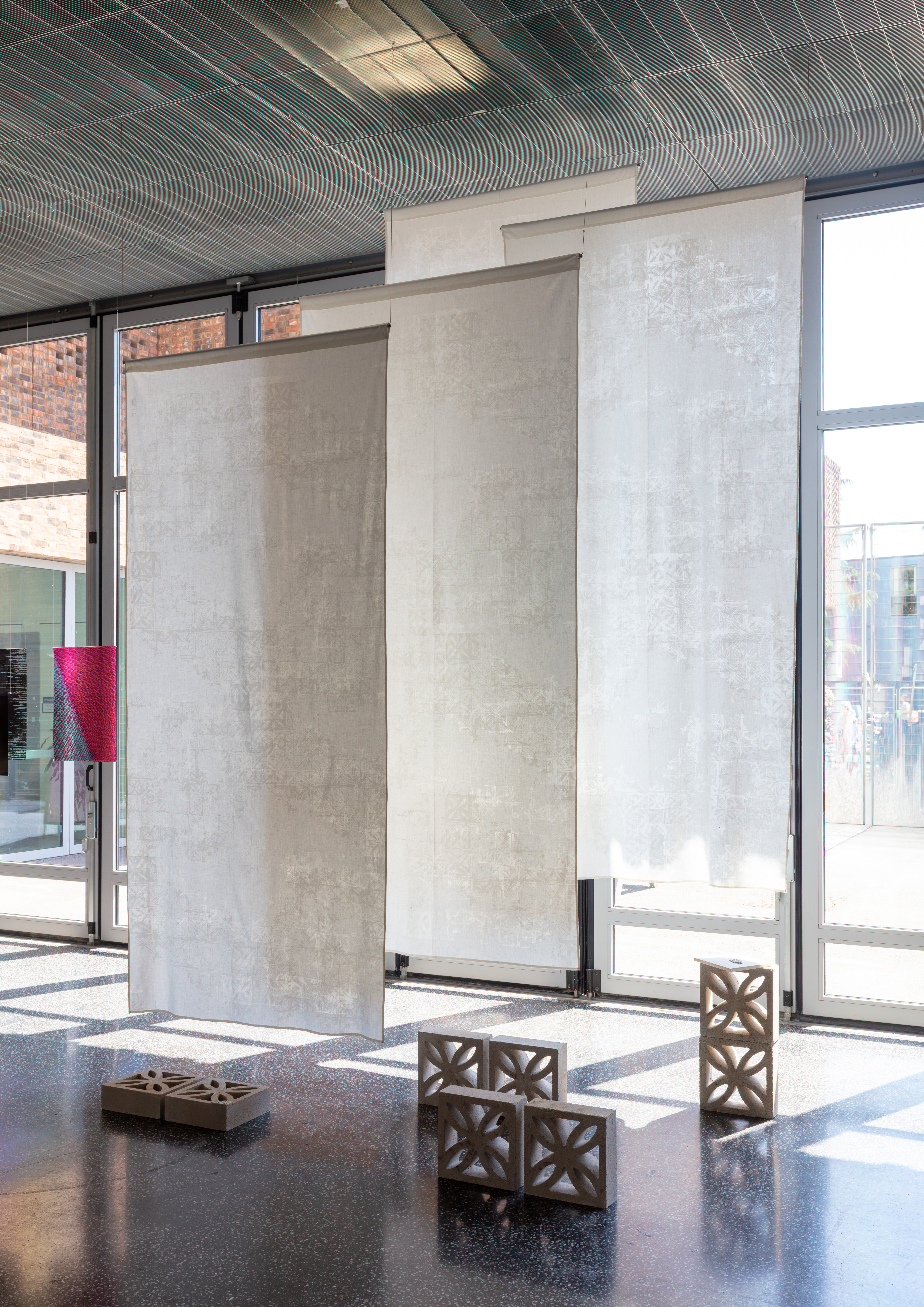 Kirsty Andrew, 'Motherlines', screen-printed textiles, reclaimed 1970s garden bricks and hand-sewn
letterpress book, installation view, Masters of Research Journeys, Hangar Space, Royal College of Art, May 2026. Photograph by Gregor Petrikovič